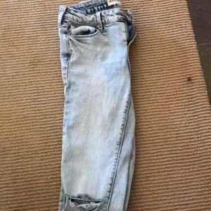 Light blue faded ripped in knee jeans